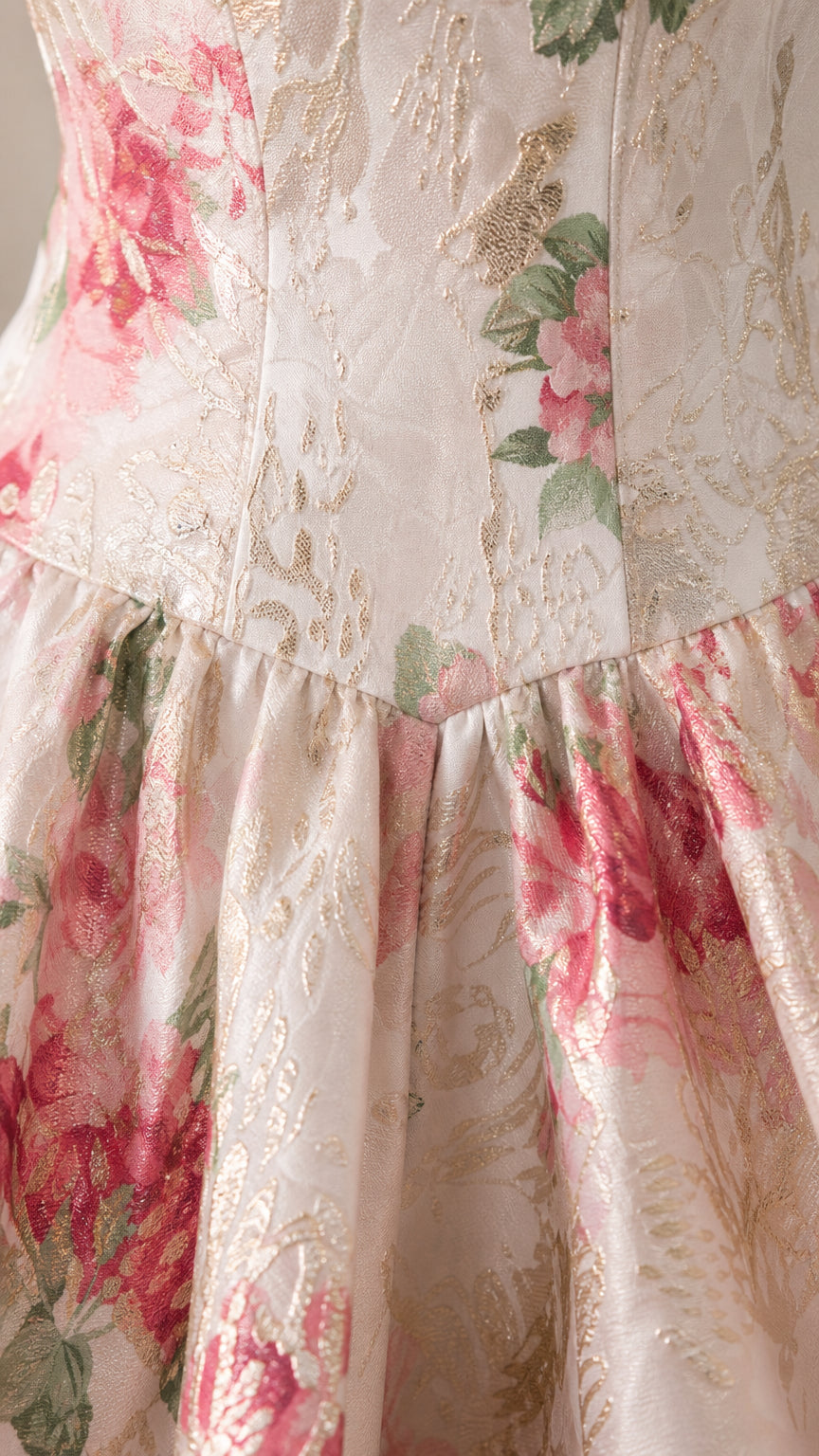 Close-up detail of white and pink floral brocade fabric texture