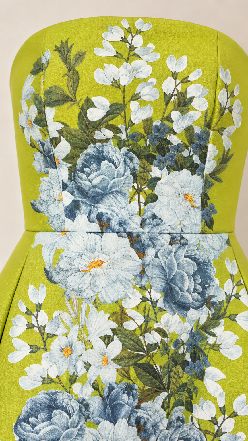 Close-up detail of blue and white floral print on lime green fabric