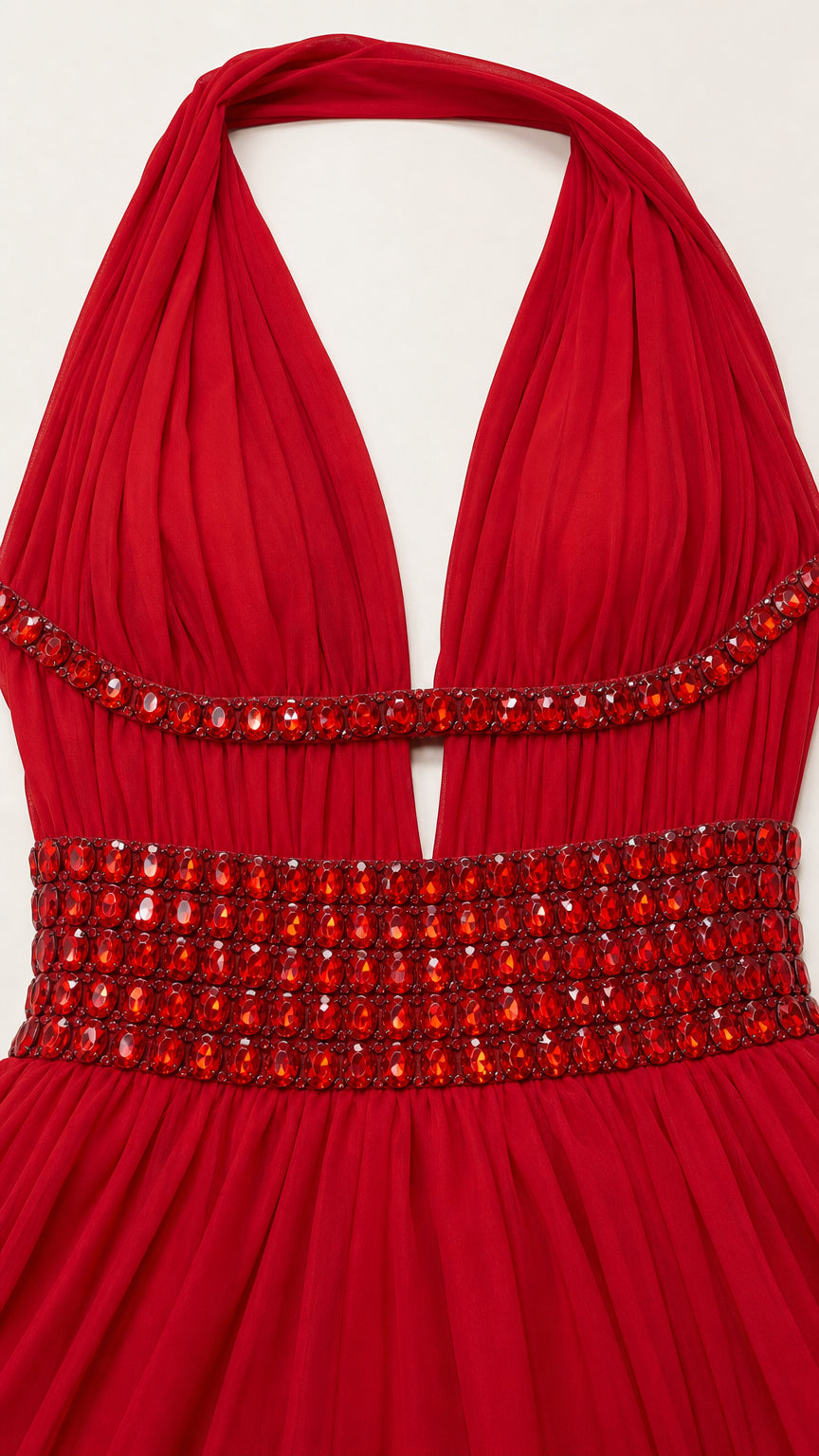 Close-up detail of red bodice showing plunging halter neckline and intricate beaded trim