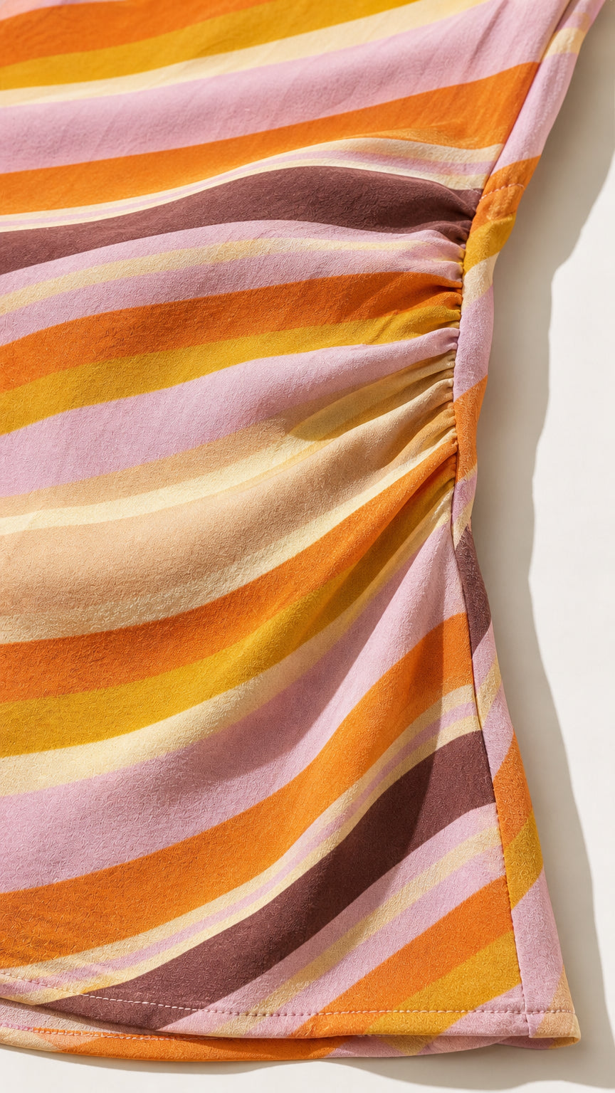 Close-up detail of fabric texture and diagonal stripe pattern with side ruching