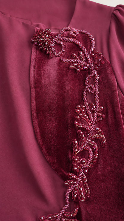 Close-up of beaded applique and velvet trim on dress bodice