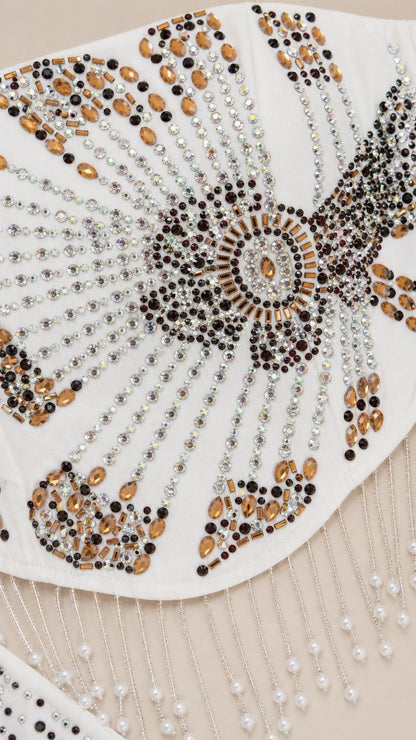 Close-up detail of intricate starburst crystal and beadwork with hanging fringe