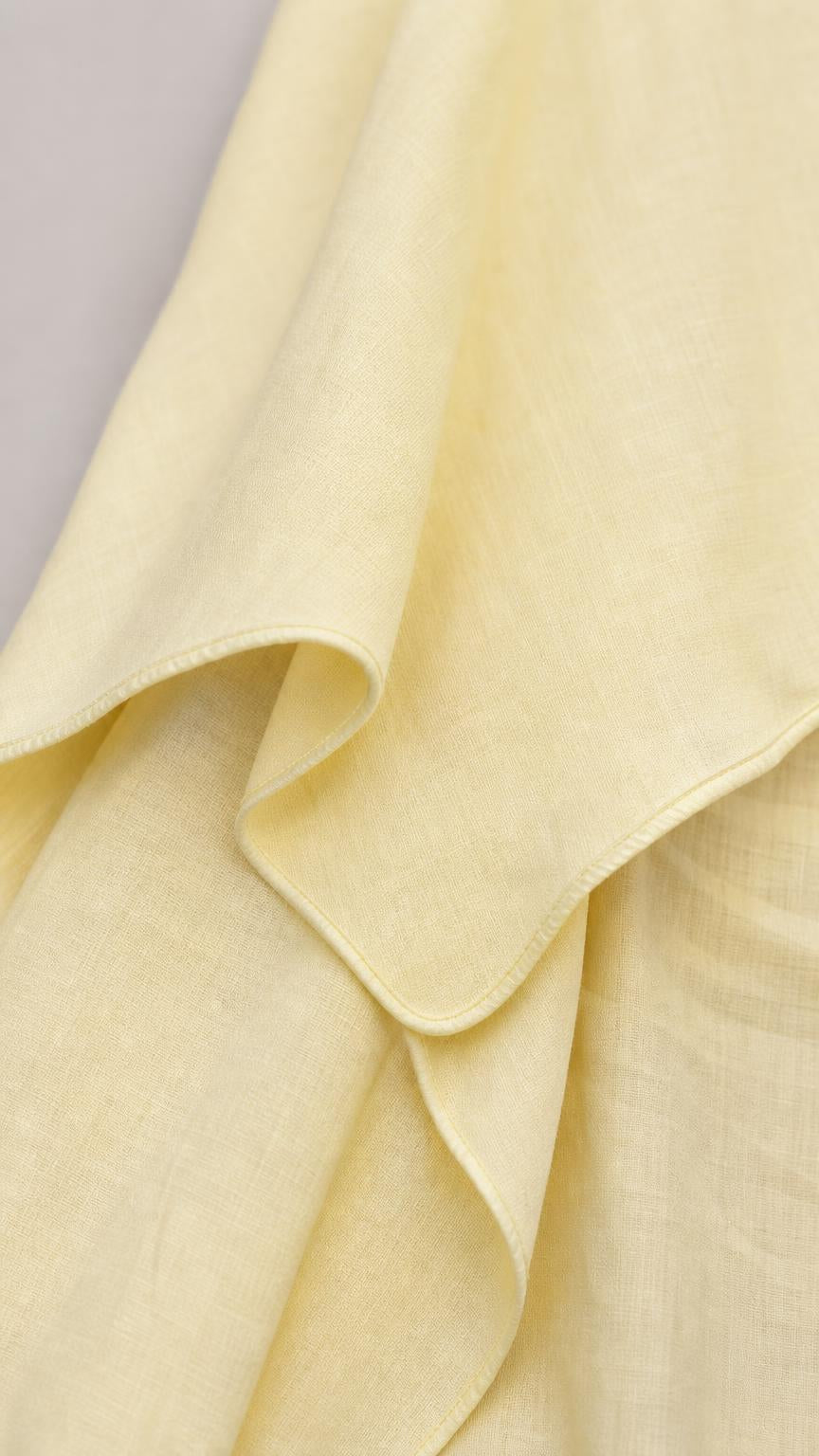 Close-up detail of the smooth yellow fabric texture and seams