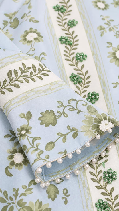 Close-up of fabric, embroidery, and pearl trim