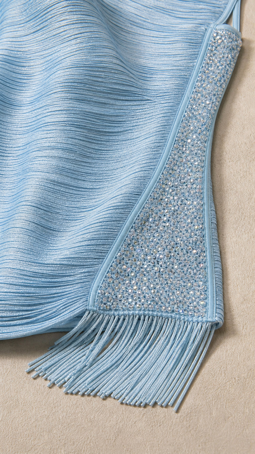 Close-up detail of rhinestone side trim and fringe hem