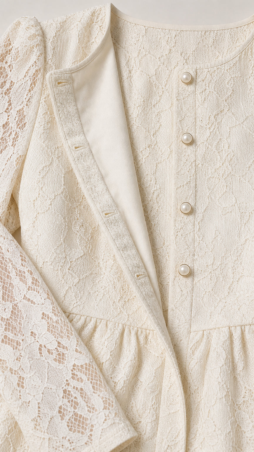Close-up detail of Cream lace fabric, pearl button accents, and smooth interior lining