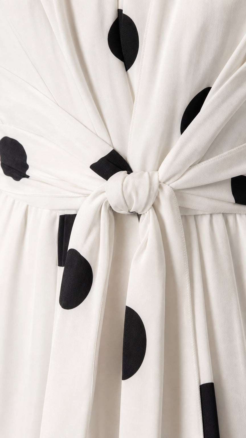 Close-up of front tie knot detail on polka dot jumpsuit