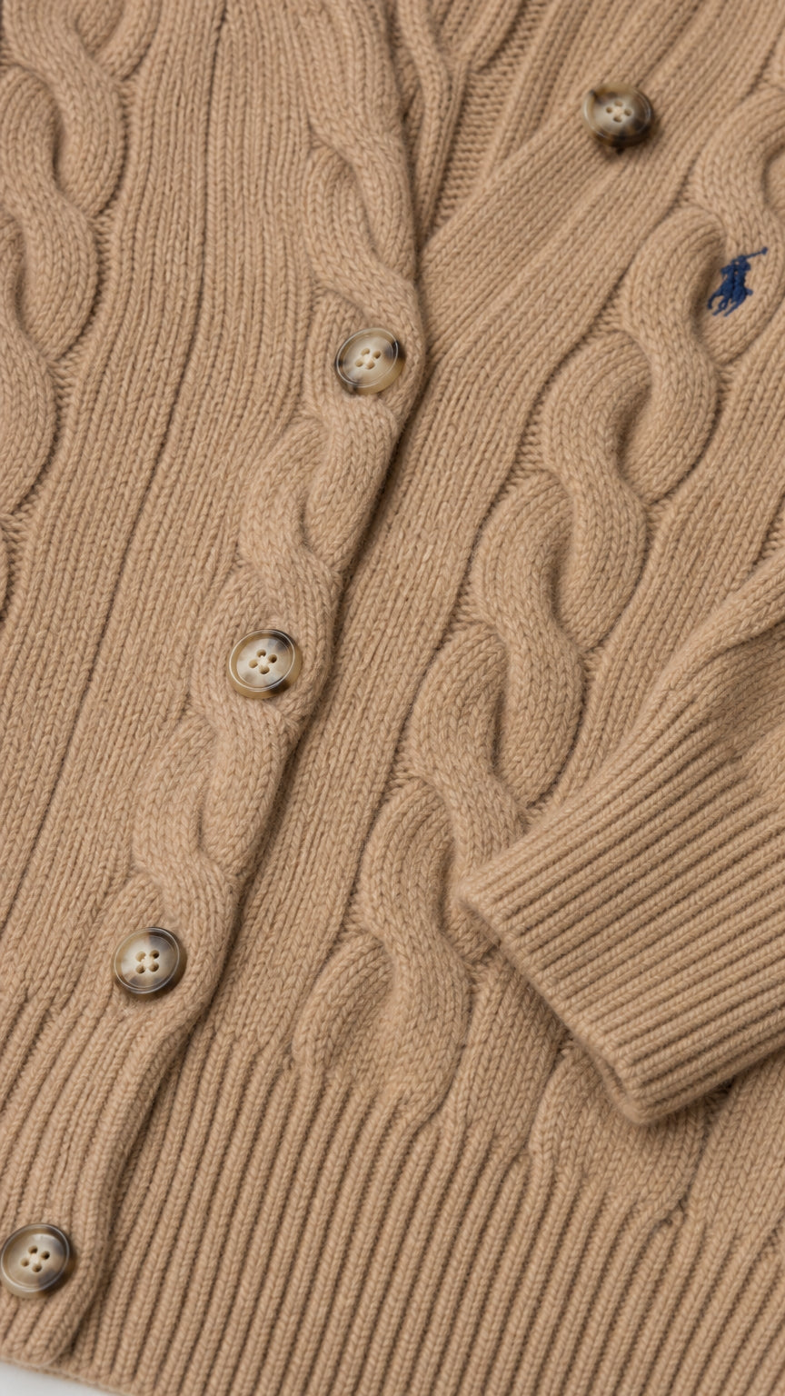 Detailed close-up of textured cable-knit pattern and button closure on camel cardigan