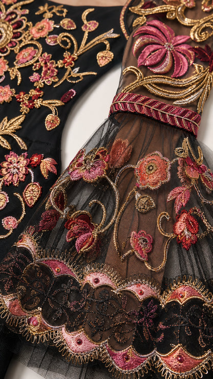 Close-up detail of floral embroidery and mesh bell sleeve