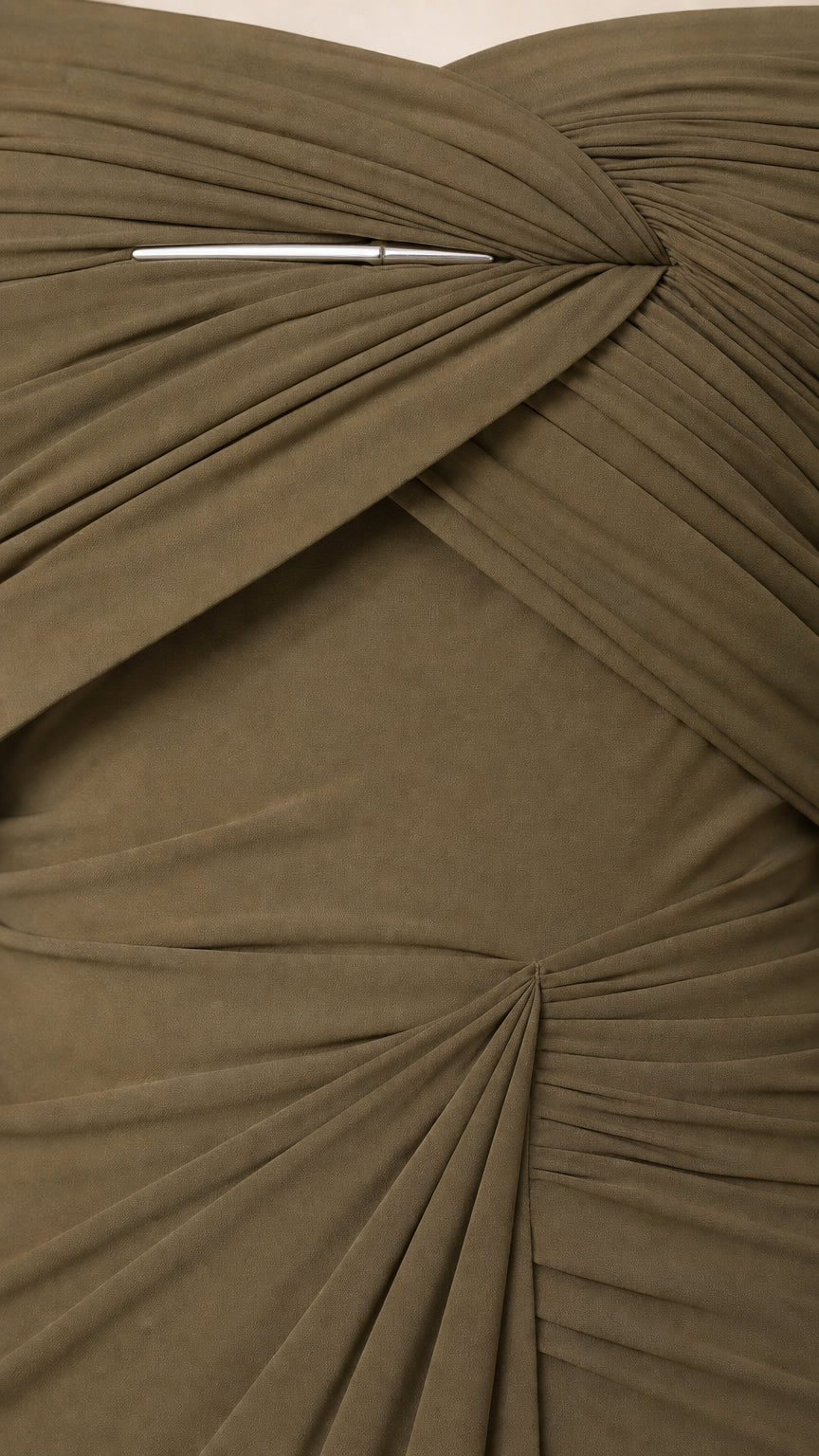 Close-up detail of bodice ruching and metallic accent