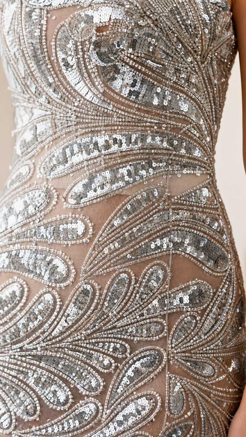 Close-up detail of intricate paisley sequin pattern on sheer mesh fabric