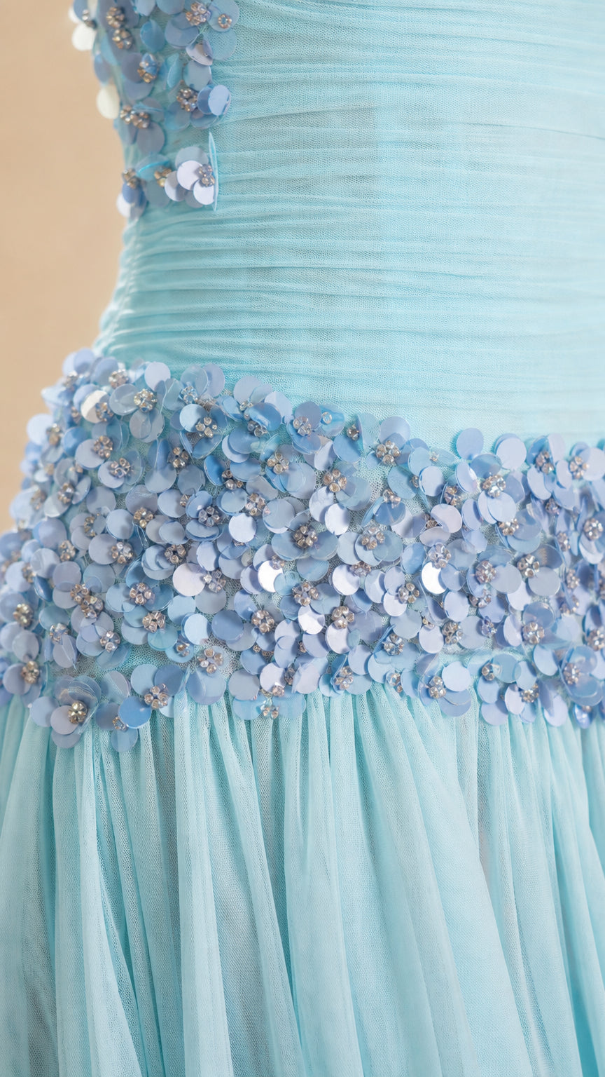 Close-up detail of 3D floral appliques and beading on the bodice