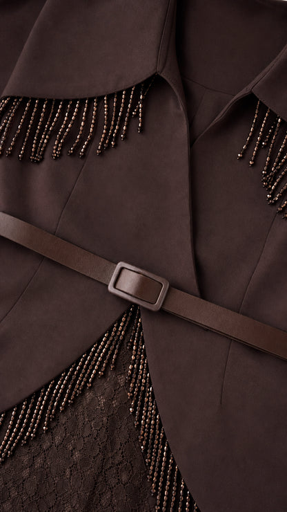 Close-up detail of beaded fringe and belt on brown gown