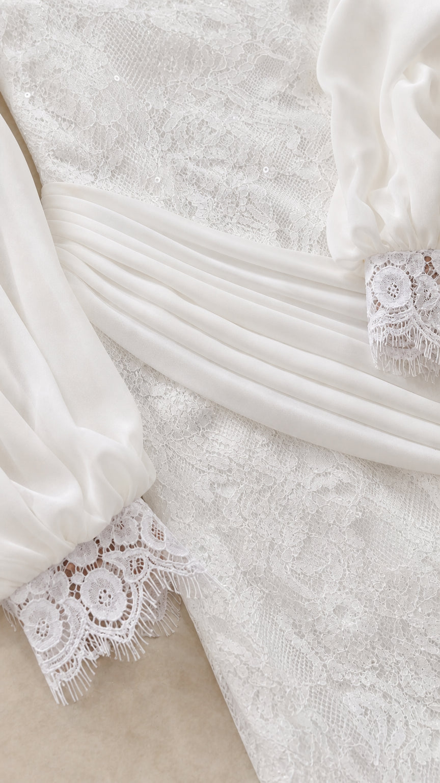 Close up of lace fabric and sleeve cuff detail