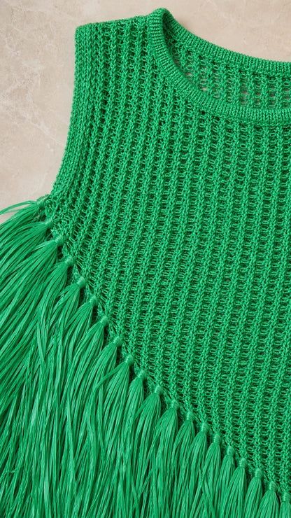 Close-up detail of green crochet knit texture and fringe