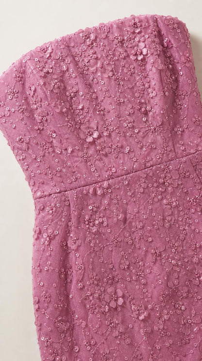 Close-up detail of 3D floral embroidery on strapless bodice