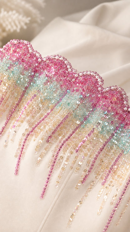 Close-up of pastel multicolor sequined and beaded drop trim along dress neckline
