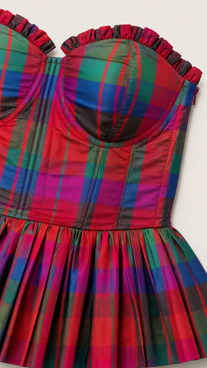 Close-up detail of the ruffled strapless bustier top in multi plaid