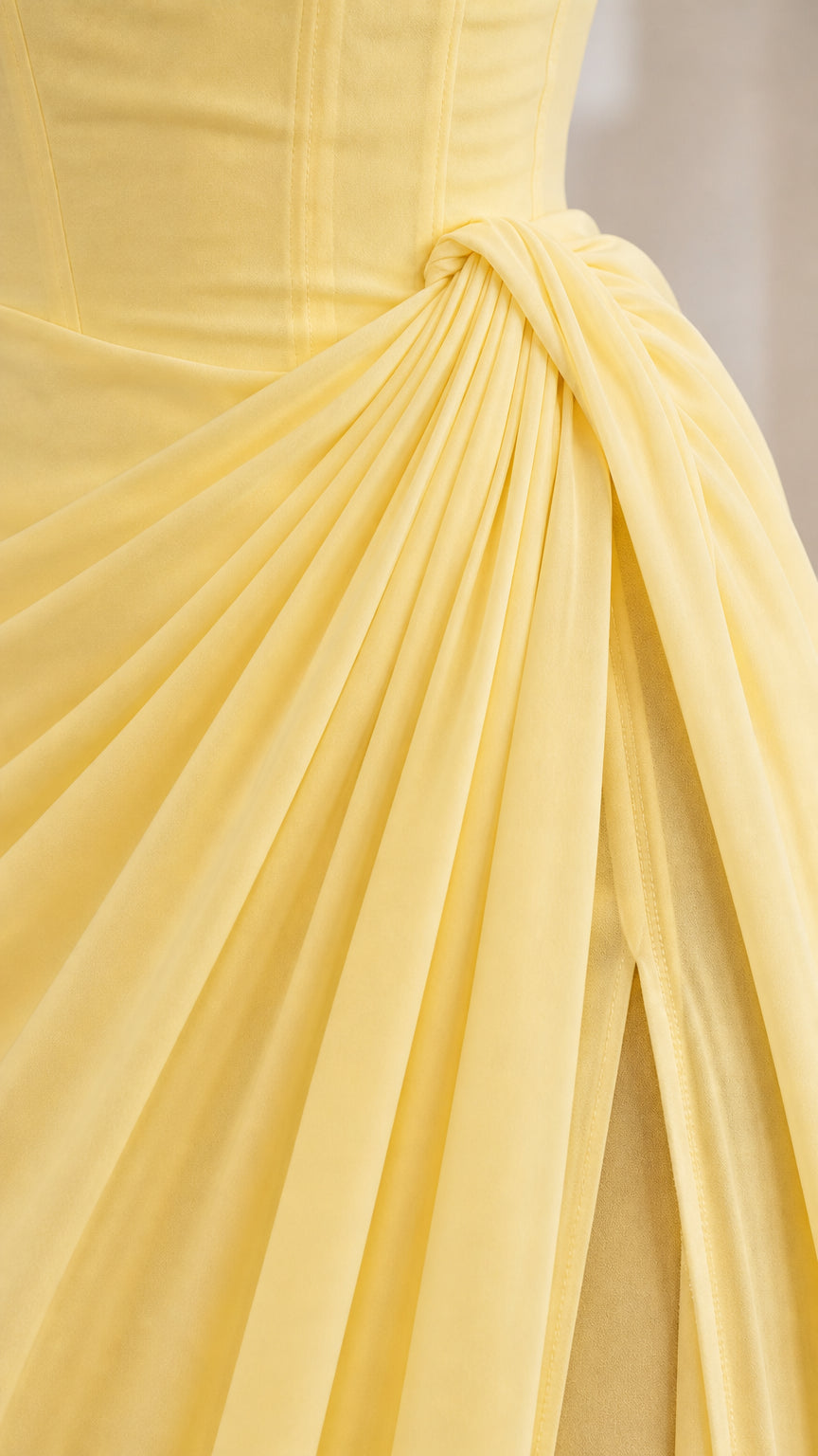 Close-up of pastel yellow side ruching and gathered drape detail
