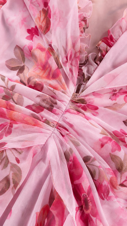 Close-up detail of pink floral chiffon fabric and ruffles