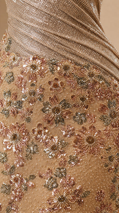Close-up of diagonal pleated bodice and intricate floral sequin embroidery