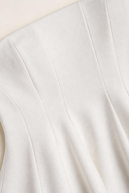 Close-up of white peplum top fabric and seaming details