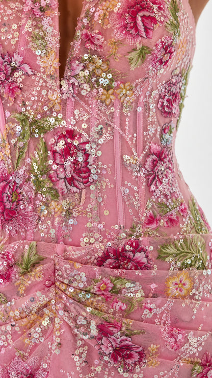 Close-up detail of floral embroidery and sequins on pink dress