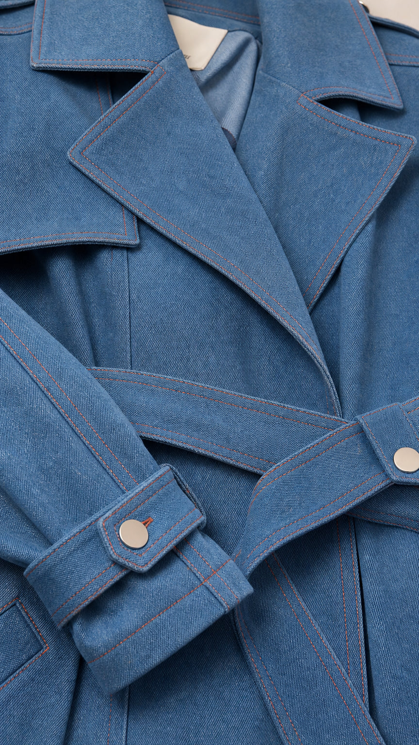 Close-up detail of Denim Blue jacket lapel, fabric weave, cuff tab, and contrast stitching