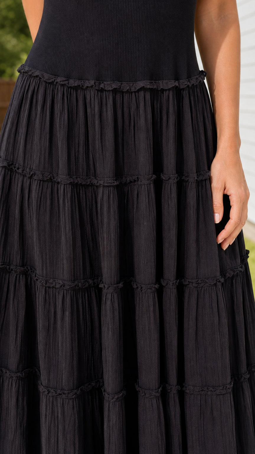 Close-up detail of tiered crinkle textured fabric on maxi skirt