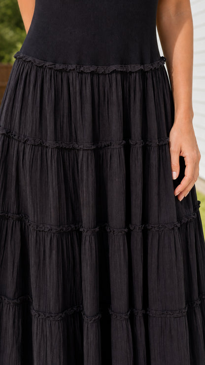 Close-up detail of tiered crinkle textured fabric on maxi skirt