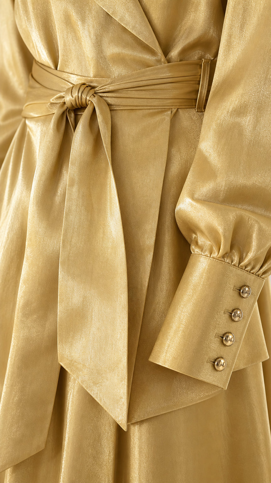 Close-up detail of the waist tie belt and buttoned cuffs on the Champagne Gold satin blazer
