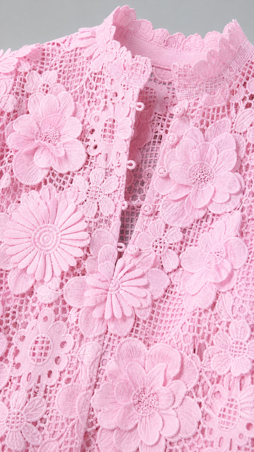 Close-up detail of floral lace texture and neckline