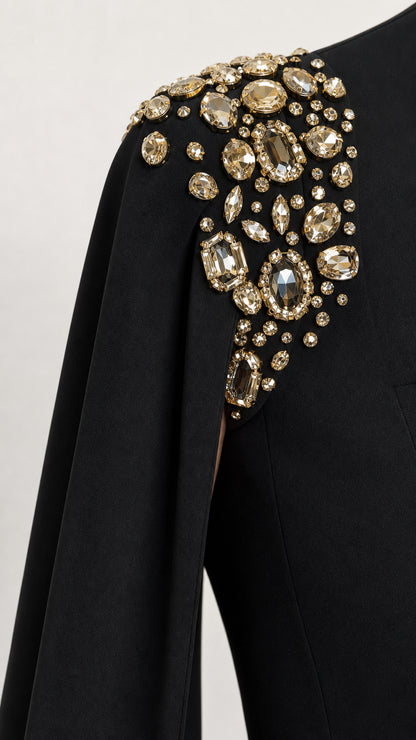 Close-up detail of luxurious crystal and gold-tone rhinestone embellishments on shoulder