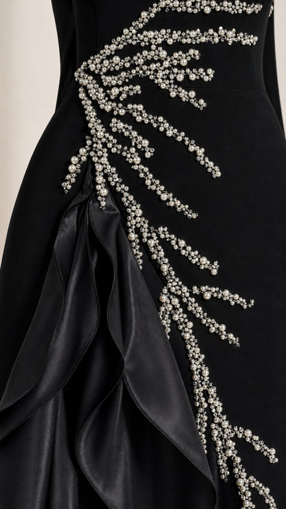 Close-up detail of pearl and crystal branch beadwork and cascading satin ruffles