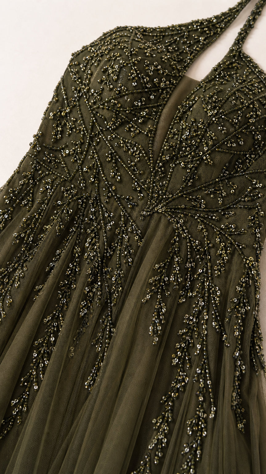 Close-up detail of intricate beadwork on the bodice of the evening gown