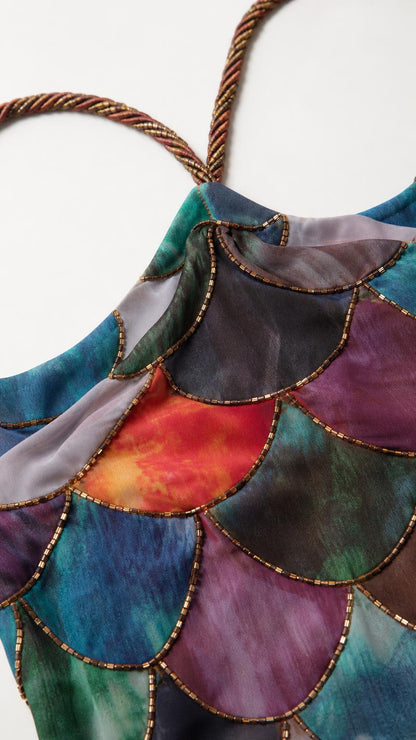 Close-up detail of the sequin scallop patchwork and braided straps