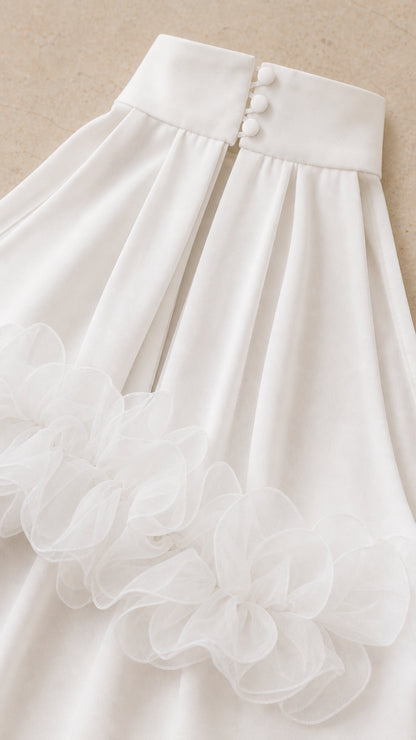 Close-up detail of high collar covered buttons and tulle ruffle trim