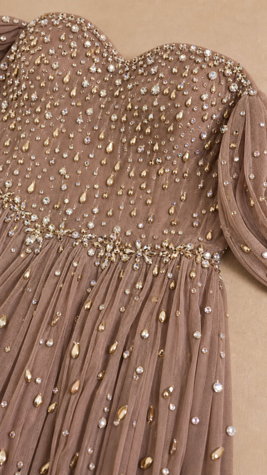 Close-up detail of sparkling rhinestone embellishments on pleated tulle bodice