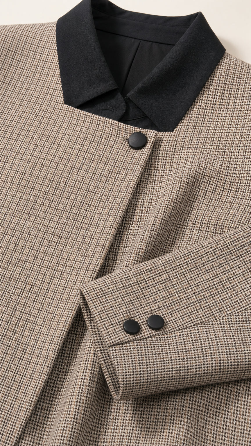 Close-up detail of micro-textured fabric, contrast black collar, and buttoned sleeve cuff