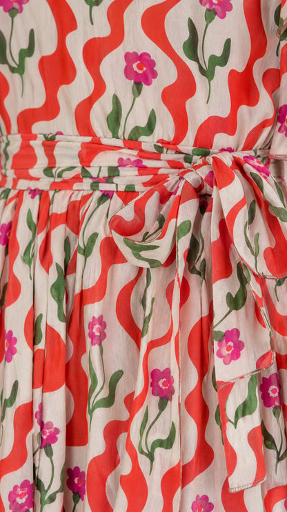 Close-up detail of red floral wave pattern and tied sash waistband