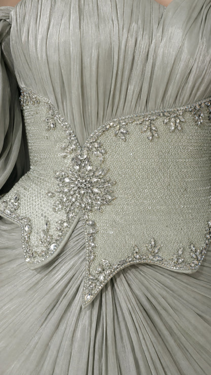 Close-up detail of Sage Green pleated bodice with crystal-embellished basque waist cincher