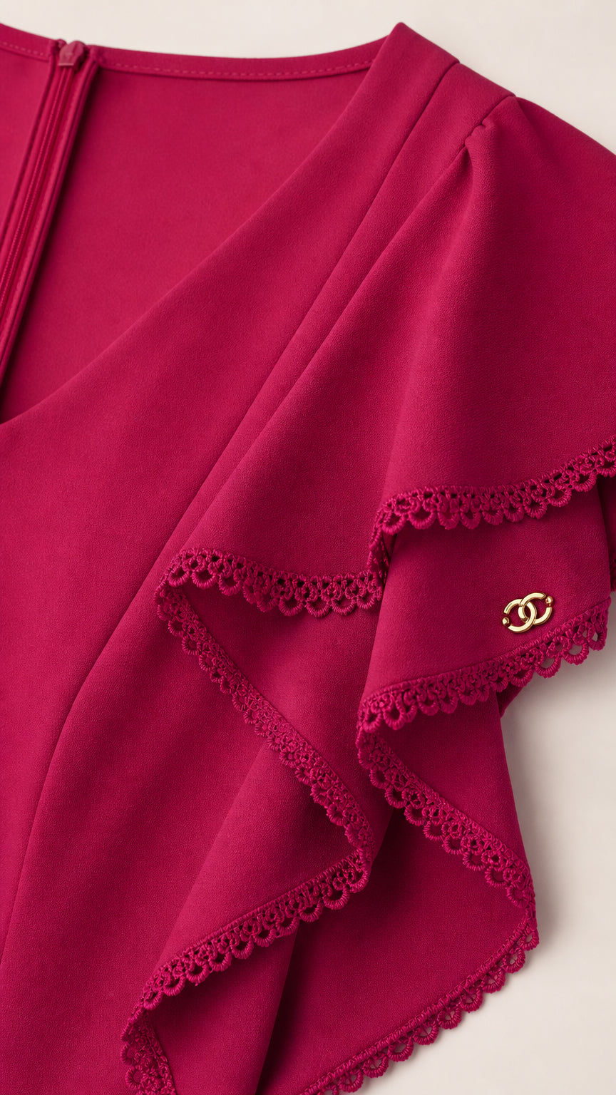 Close-up of fuchsia flutter sleeve and crochet lace detail