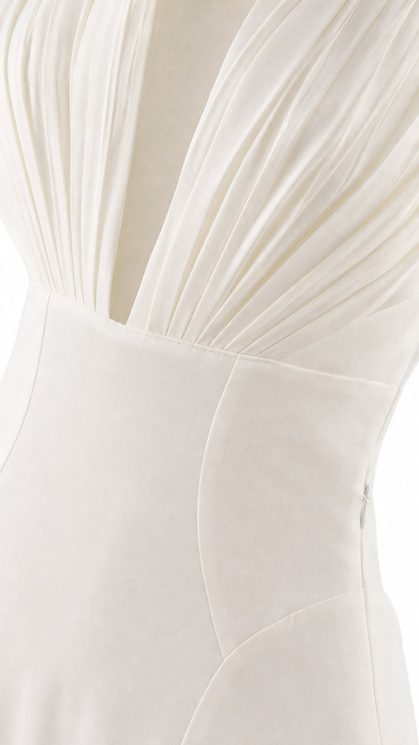 Close-up detail of pleated bodice and high waist seam on white dress