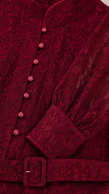 Close-up detail of Burgundy lace fabric, covered buttons, and belted waist
