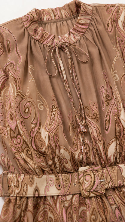 Close-up of neckline and belt detail on camel dress