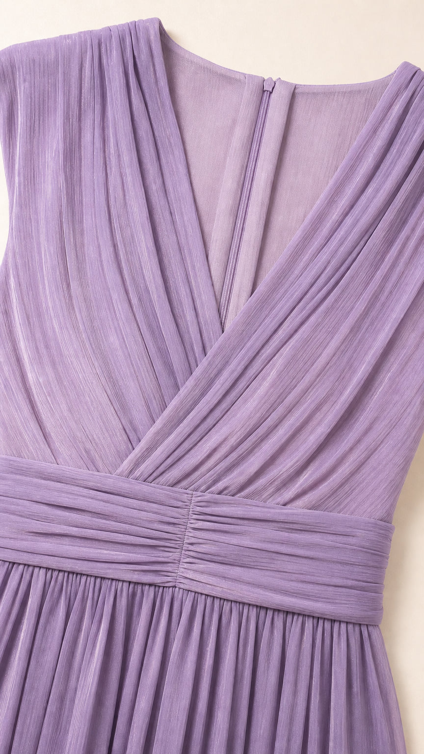 Close-up detail of pleated crossover V-neckline and ruched empire waistband