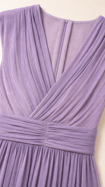 Close-up detail of pleated crossover V-neckline and ruched empire waistband