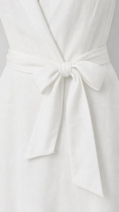 Close-up detail of self-tie bow belt on white dress