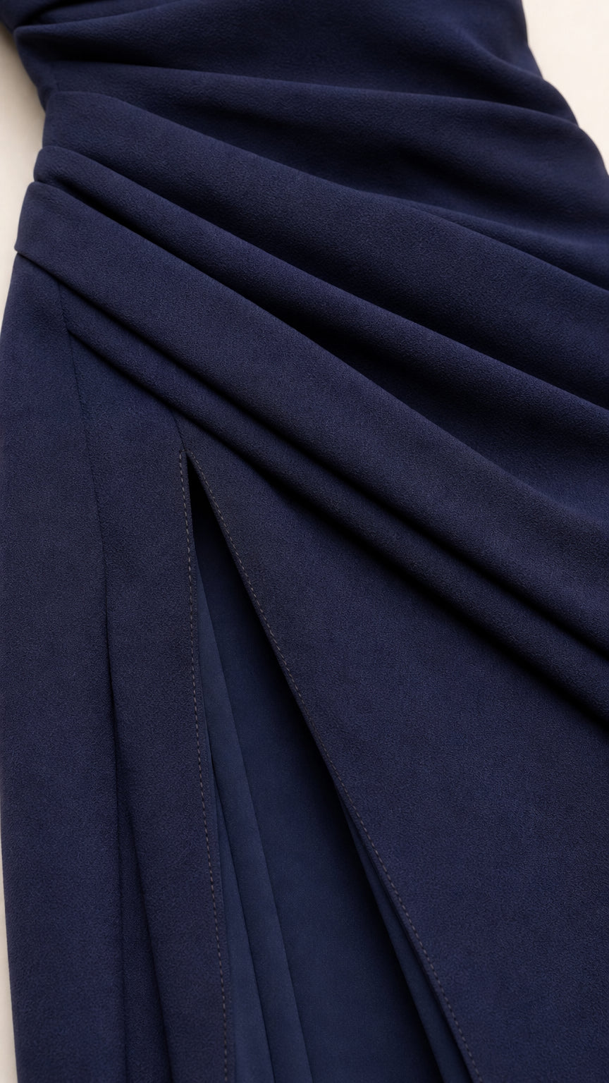 Close-up detail of navy fabric texture and side slit construction