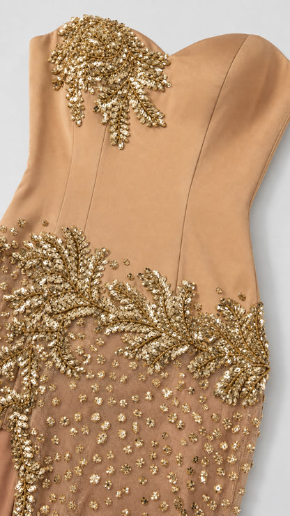 Close-up detail of intricate gold leaf beadwork on champagne satin bodice